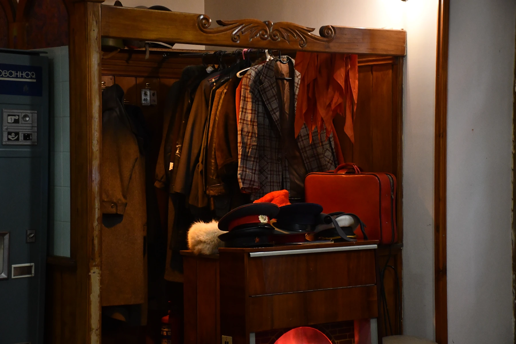 Original Soviet-era clothing, hats and a suitcase displayed at Soviet Club
